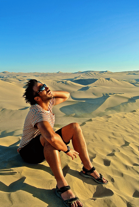 Chris allows the wind to flow through his hair atop the dunes at Huacachina