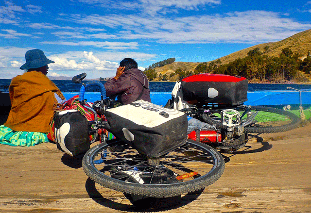 A bike, a barge, and two Bolivians.  Crossing the lake