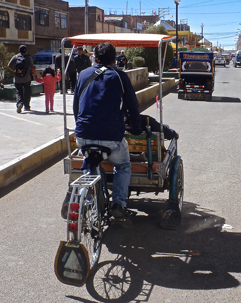 A cycle rickshaw on the way out of Puno. I've ridden one of these with Mel and the driver in. Hard bloody work!